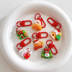 Cute Christmas keychain pendant set featuring various cartoon Santa and tree holiday designs.