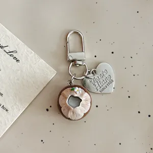 Cute simulated coconut food toy keychain bag charm with metal heart tag aesthetic accessory.