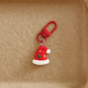 Cute Christmas hat keychain detail, red resin pendant charm for bag backpack decoration.
