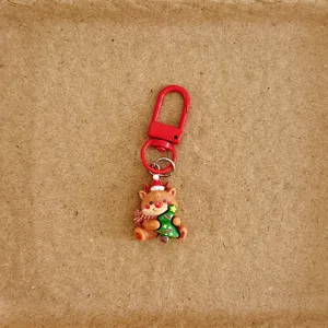 Llavero lindo de reno navideño con broche rojo, colgante festivo para bolso de temporada.
