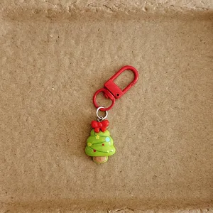 Cute Christmas tree bag charm close-up detail, festive cartoon hanging ornament for holiday gifts.