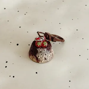 Detailed shot of a cute simulation strawberry chocolate cake keychain, perfect bag pendant and gift.