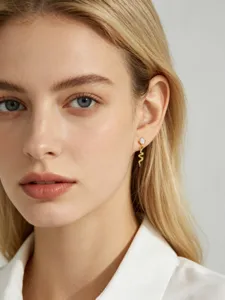 Detailed close-up of golden snake shaped S925 silver earring with sparkling zircon