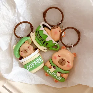 Close-up detail of cute capybara coffee cup keychain pendant, adorable backpack accessory.