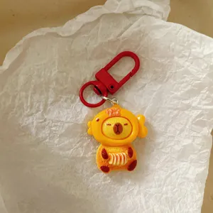 Cute capybara keychain detail, red metal clasp, adorable cartoon bag charm accessory.