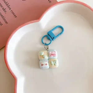 Cute cartoon four-grid bread cat and pig keychain detail, sweet style bag charm accessory.