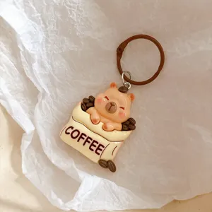Cute capybara coffee cup keychain charm, detailed resin animal backpack pendant accessory.