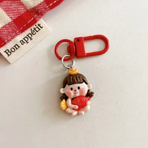 Adorable cartoon doll keychain detail showing red metal clasp and cute lucky figurine.