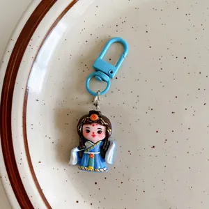 Cute Chinese style cartoon girl keychain pendant detail, ethnic costume backpack charm.