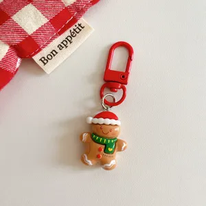 Cute Christmas gingerbread man keychain with red metal clasp, festive backpack pendant gift.