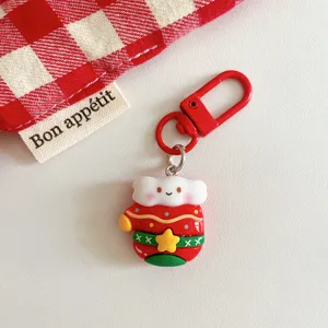 Cute Christmas keychain detail shot featuring a festive cartoon charm with red metal clasp.