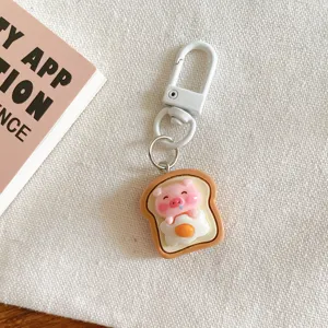 Cute cartoon pig toast keychain pendant, lovely resin bag hanging ornament and accessory.