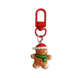 Cute Christmas gingerbread man keychain bag charm with red clasp and green scarf for gifts.
