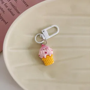 Charming cartoon ice cream keychain detail view, cute resin pendant with white metal clasp.