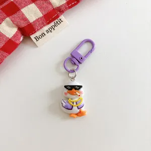 Cute cartoon thug duck keychain bag pendant accessory with purple clasp and funny design.