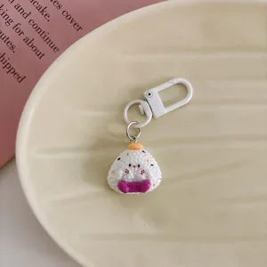Cute cartoon rice ball keychain with white clasp, lovely kawaii bag pendant accessory for students.
