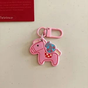 Pink cartoon horse keychain with money bag charm, stylish bag pendant and cute gift accessory.