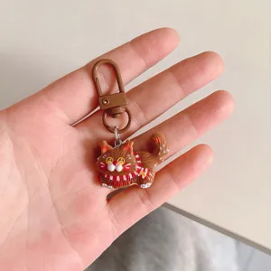 Cute cartoon brown cat keychain detail view, lovely bag charm and backpack accessory.