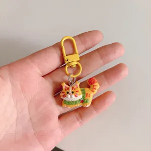 Cute cartoon cat keychain pendant with yellow metal clasp, creative bag charm accessory gift.