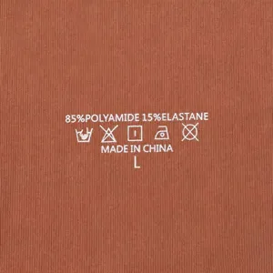 Close-up detail of inner wash care label showing material composition and size info.