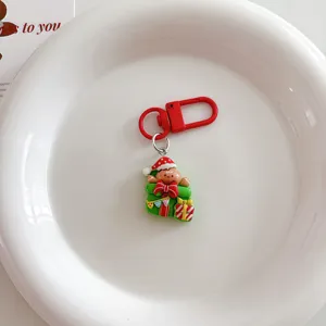 Cute Christmas gingerbread man keychain detail shot, red gift bag bag charm holiday ornament.