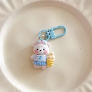 Cute cartoon surfing bear keychain for cute girls, stylish bag charm and school bag accessory.