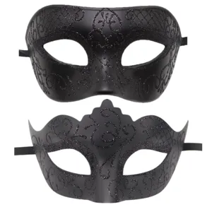 Close-up details of black masquerade masks with glitter patterns, ideal for party decor.