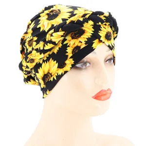 Detail view of the sunflower printed braided turban cap crafted from soft milk silk fabric.