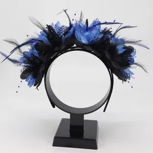 Close-up detail of the stunning black and blue feather flower headband for party hair decor.