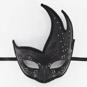 Close-up detail of the black Venetian masquerade mask with glitter and swan horn design.