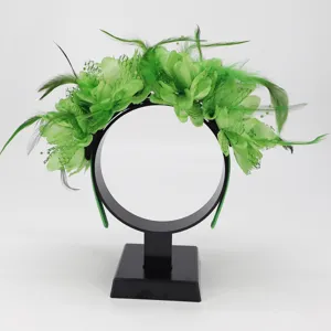 Green feather flower headband detail showing delicate petals and mesh design for parties.