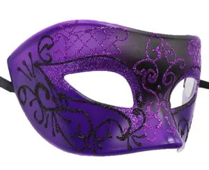 Detailed close-up view of a purple and black masquerade mask with sparkling glitter patterns.