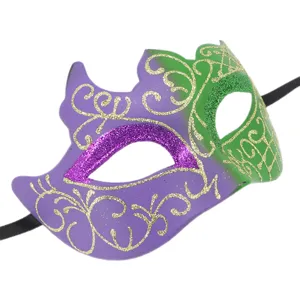Close-up of purple and green masquerade mask with gold glitter patterns and strap.