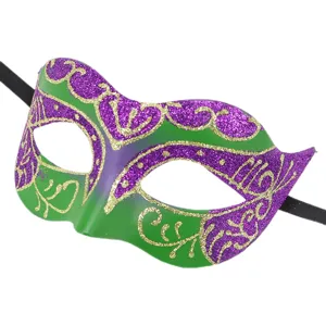 Detailed close-up of green and purple carnival masquerade mask with sparkling gold glitter.