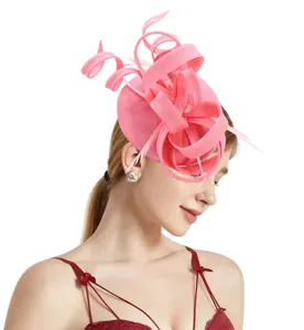 Pink sinamay fascinator hat detail view, elegant feather headwear for party and wedding.