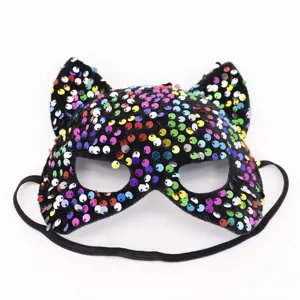 Detailed view of a sequin cat mask, black fabric with colorful sequins and elastic strap.