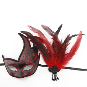 Red black masquerade mask with feather fringe and glitter details for party and Halloween events.