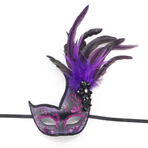 Close up of purple masquerade mask with black feathers, glitter details and ribbons.