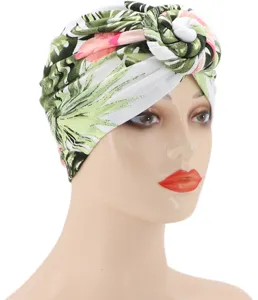 Primer plano del detalle del turbante con estampado tropical, tejido de seda de leche, nudo.