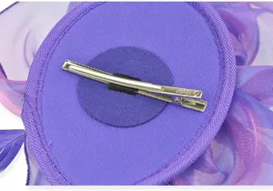 Detailed close-up view of the purple organza fascinator feather hair clip for elegant parties.