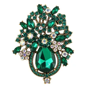 Detailed view of vintage green crystal flower basket brooch with sparkling rhinestones.