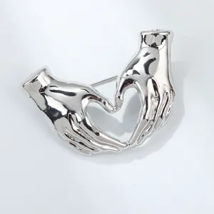 Silver hands heart brooch creative minimalist niche metal clothing pin fashion accessory detail shot