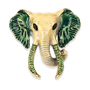 Close-up detail of vintage green enamel rhinestone elephant head brooch luxury accessory.