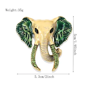 Vintage enamel elephant head brooch with green rhinestones, exquisite suit coat pin accessory.
