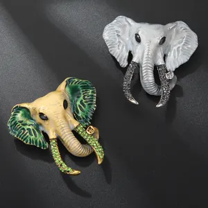 Detailed shot of vintage elephant head brooches with enamel and sparkling rhinestones.