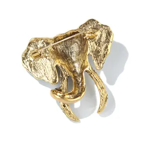 Detailed view of the back of a vintage gold tone elephant brooch with secure pin clasp.