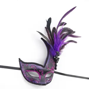 Detailed view of the gorgeous purple feather masquerade mask with glitter and ribbons.