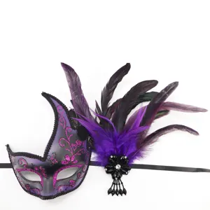 Detailed close-up of a glamorous purple and black feather masquerade mask with glitter and crystal.