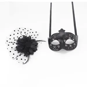 Detailed view of a black glittery masquerade eye mask and matching floral feather hair clip