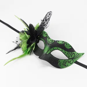 Detailed view of black green masquerade mask with mesh flower and feathers for Halloween party.
